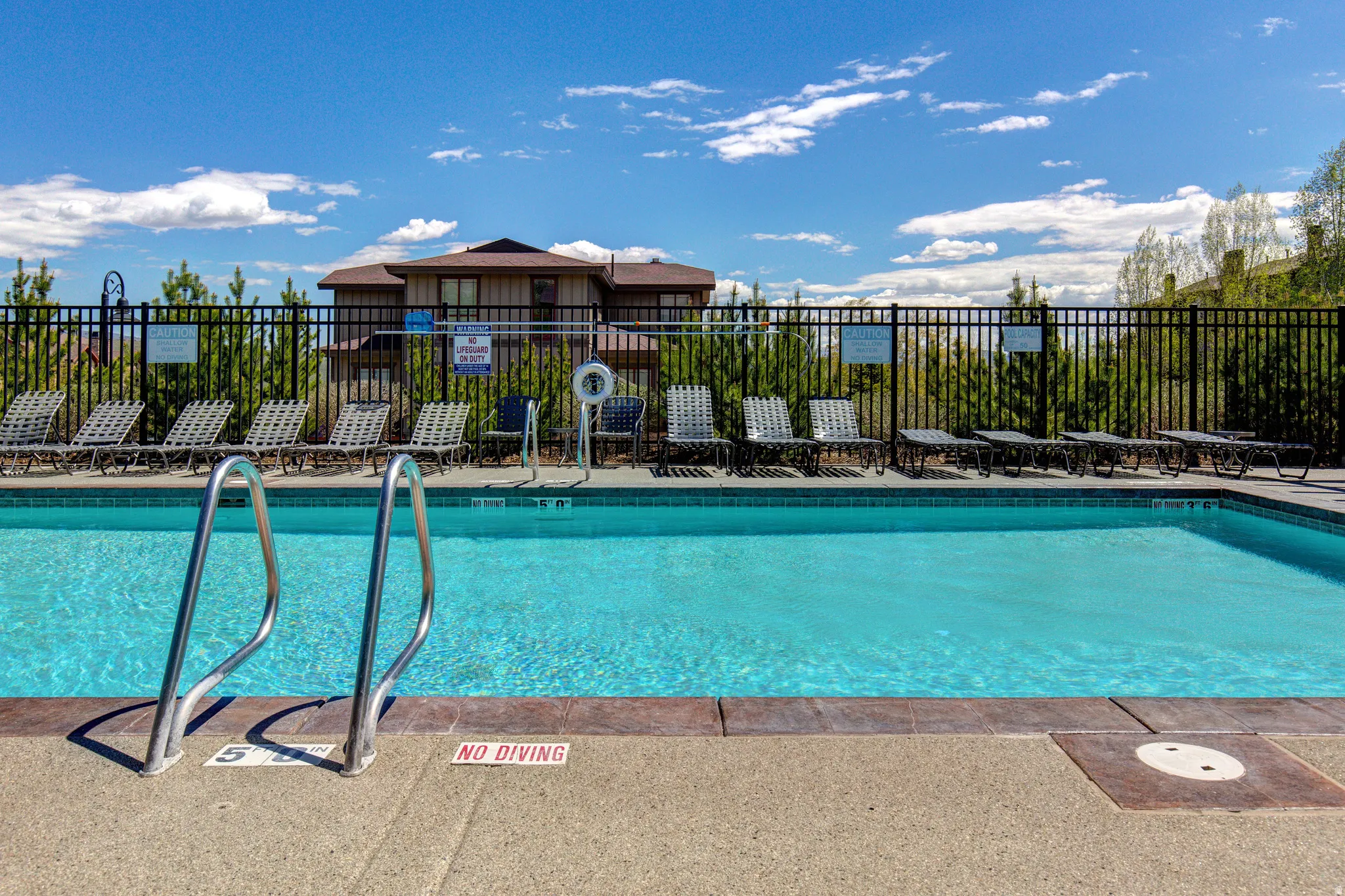 Community pool with a patio