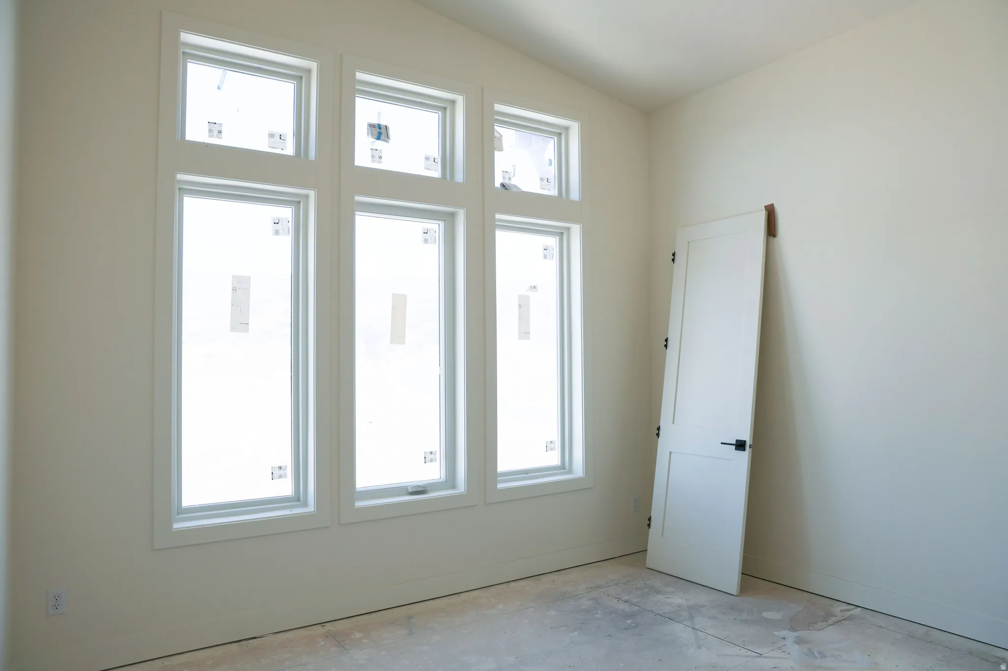 Unfurnished room featuring lofted ceiling