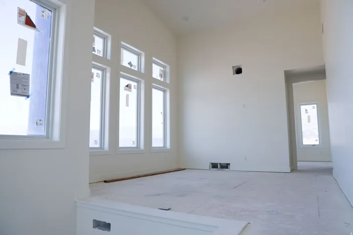 Unfurnished room with a high ceiling