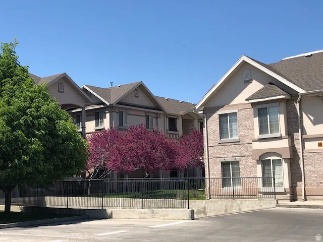 View of front of house featuring a fenced front yard, stucco siding, and brick siding