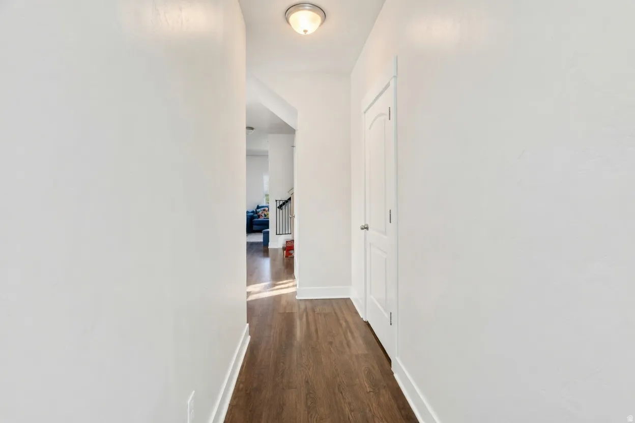 Corridor with baseboards and dark wood finished floors