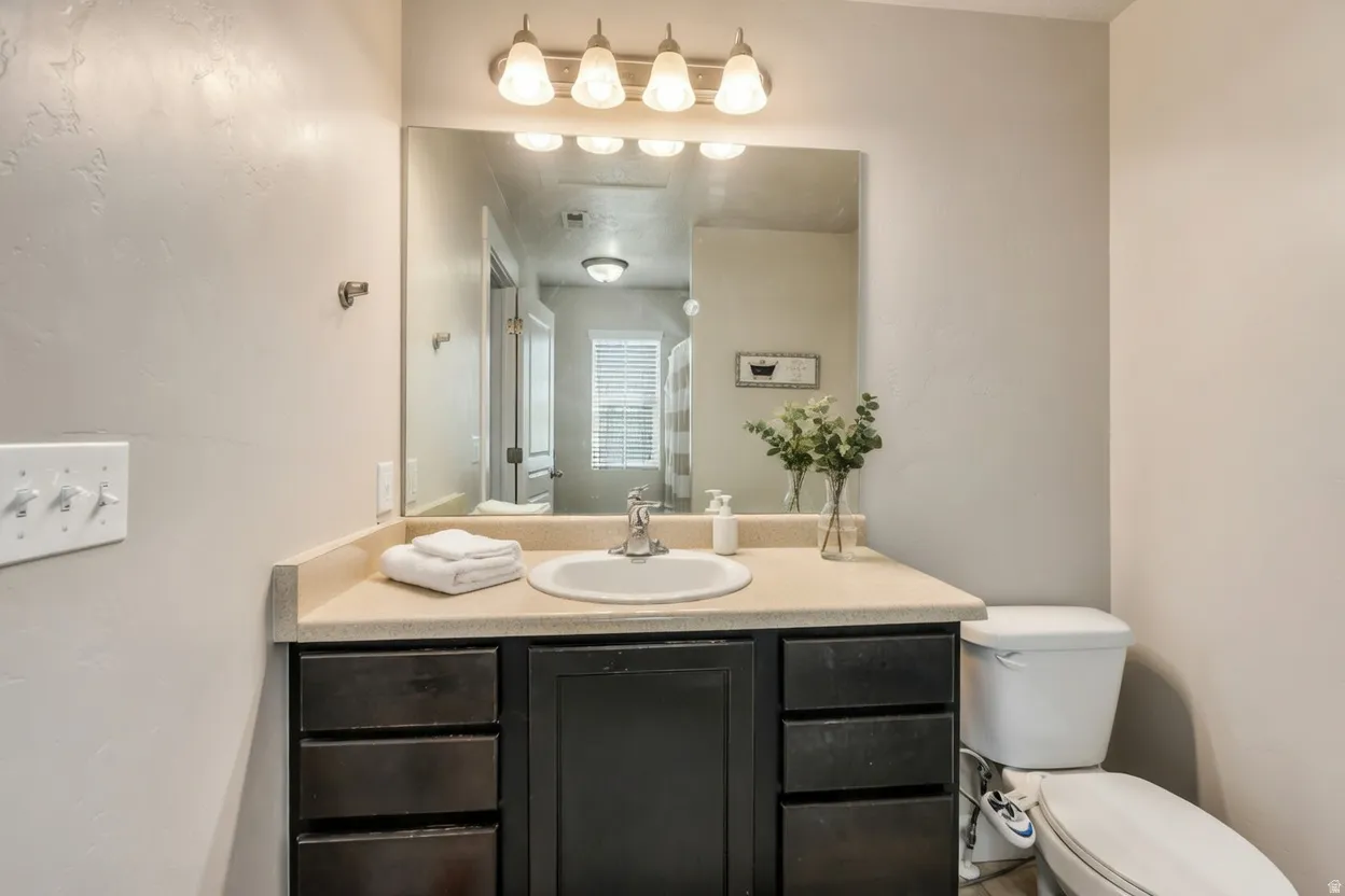 Half bathroom with vanity and toilet