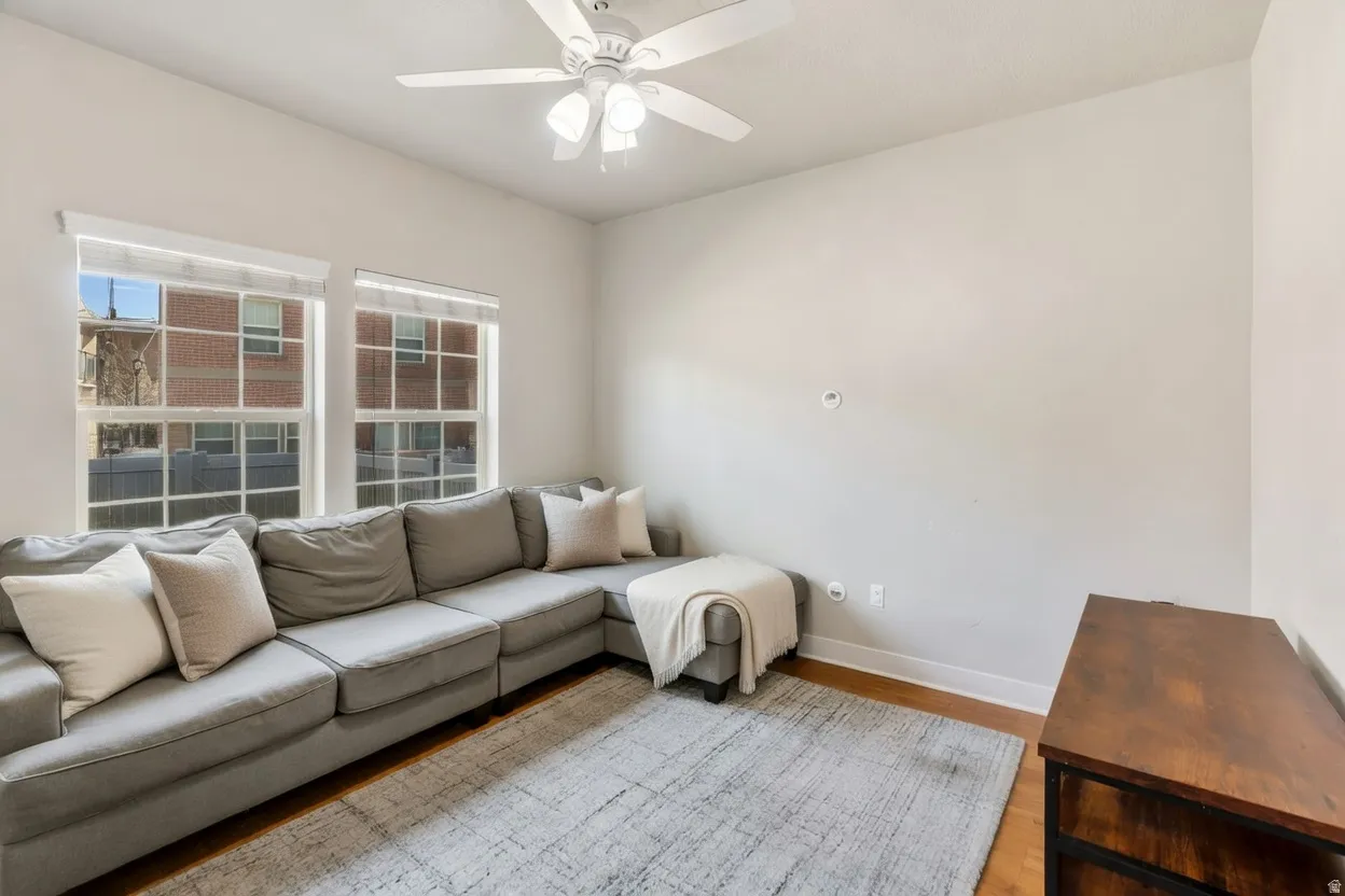 Living room featuring light wood-type flooring and ceiling fan