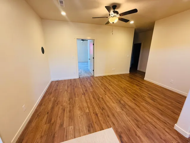 Spare room featuring dark wood finished floors, recessed lighting, and a ceiling fan