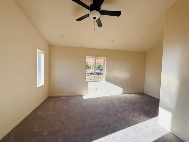 Master featuring carpet flooring and a ceiling fan