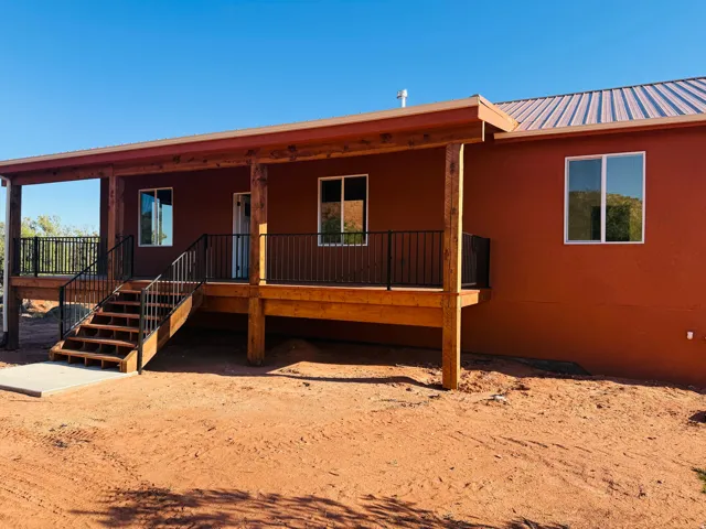 View of front of property with a porch, a metal roof, and stucco siding