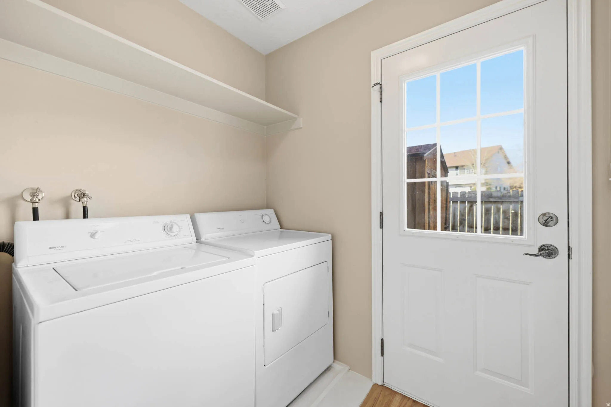 Laundry Area with Full Pantry Closet on Opposite Wall