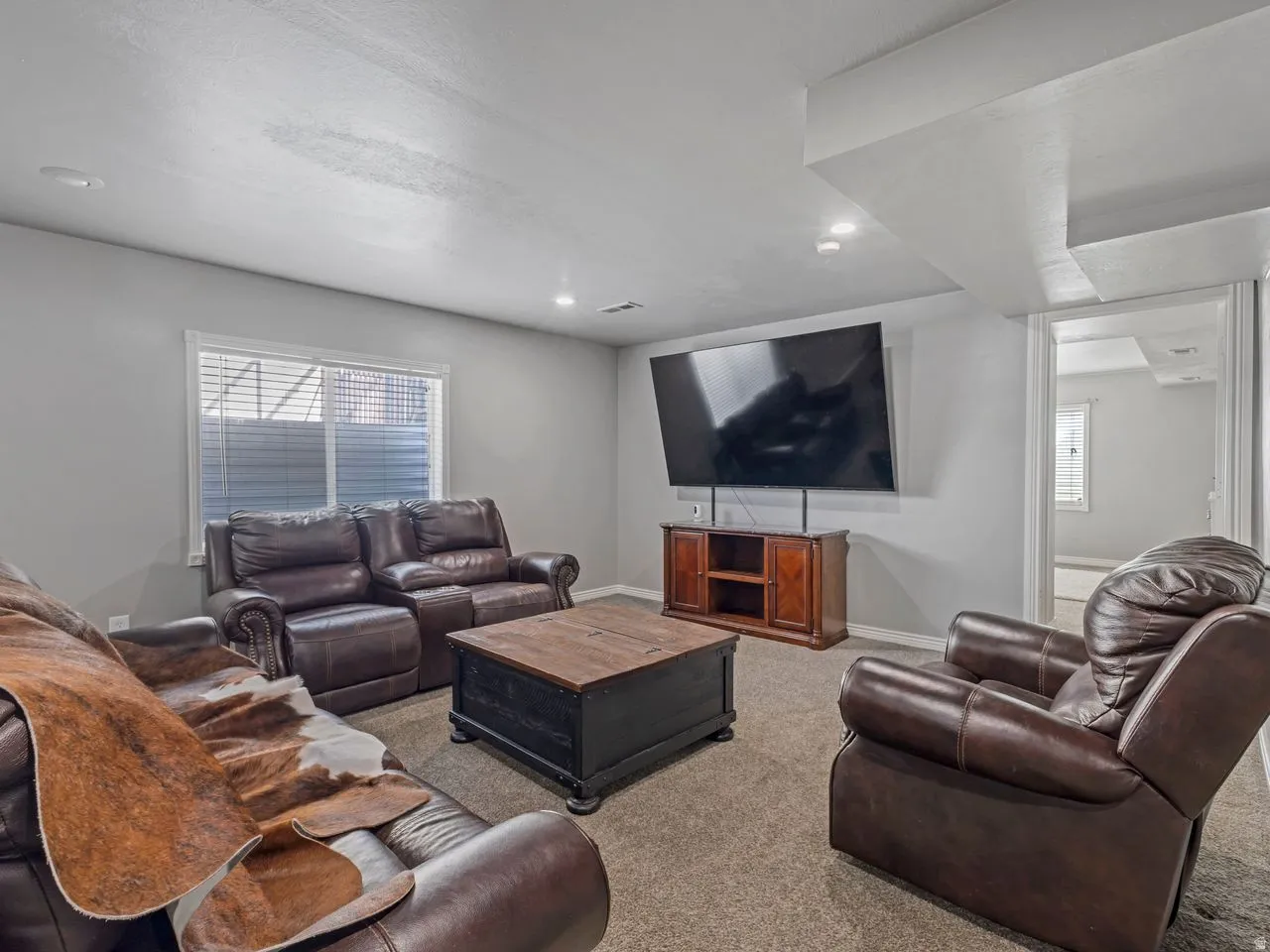 Living area featuring light carpet and recessed lighting