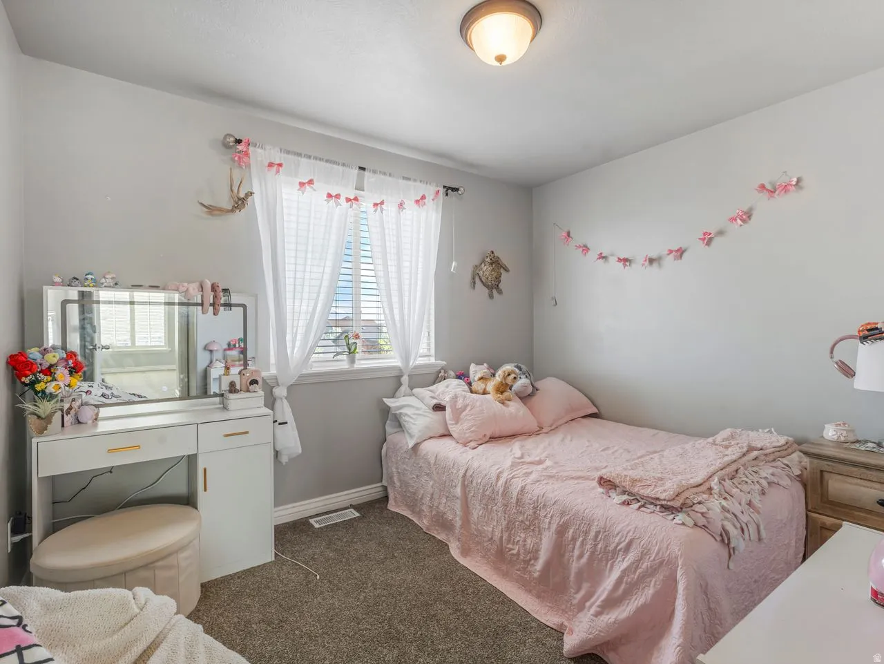 Bedroom with dark colored carpet and baseboards