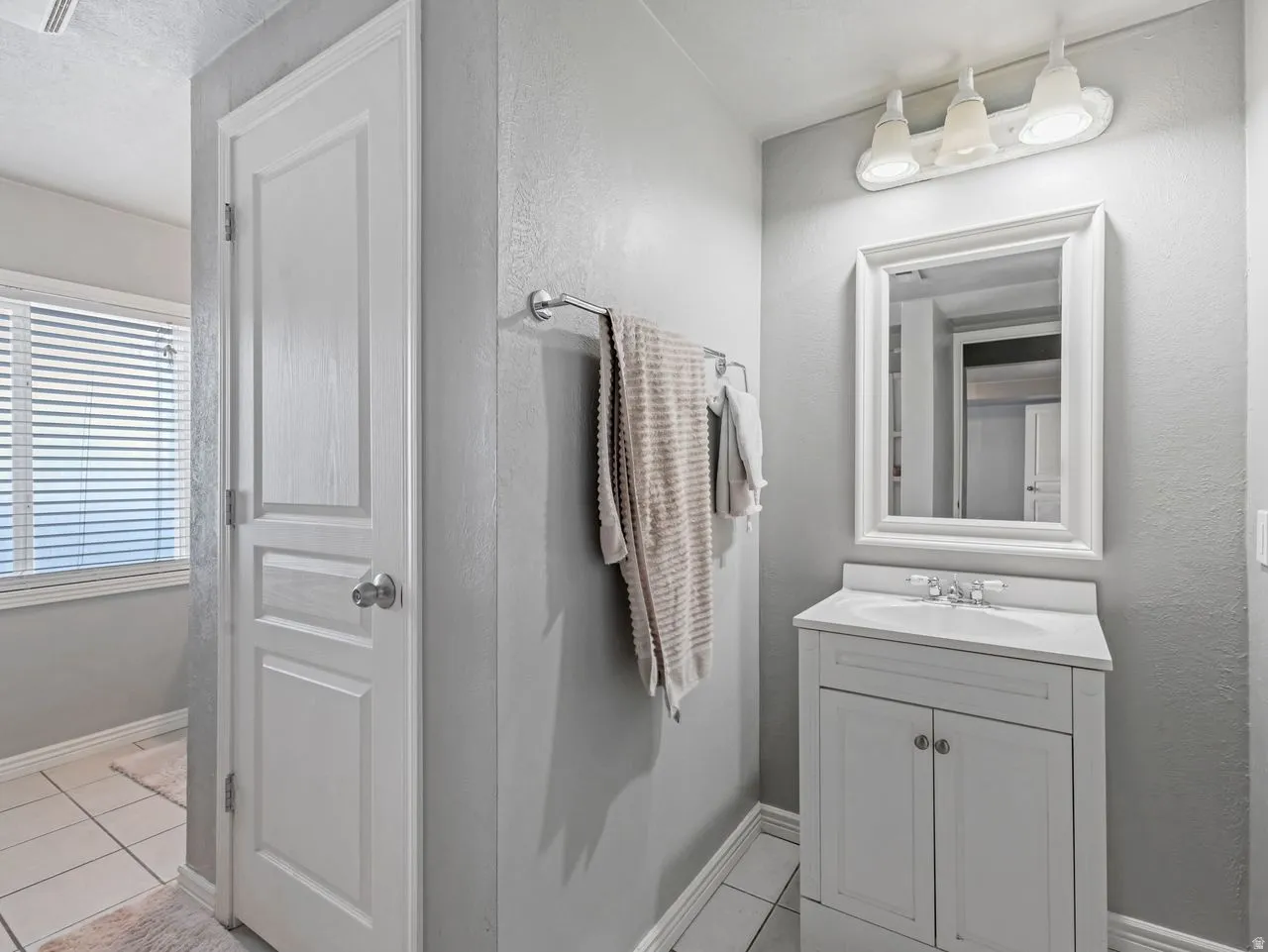 Bathroom featuring vanity and light tile patterned flooring