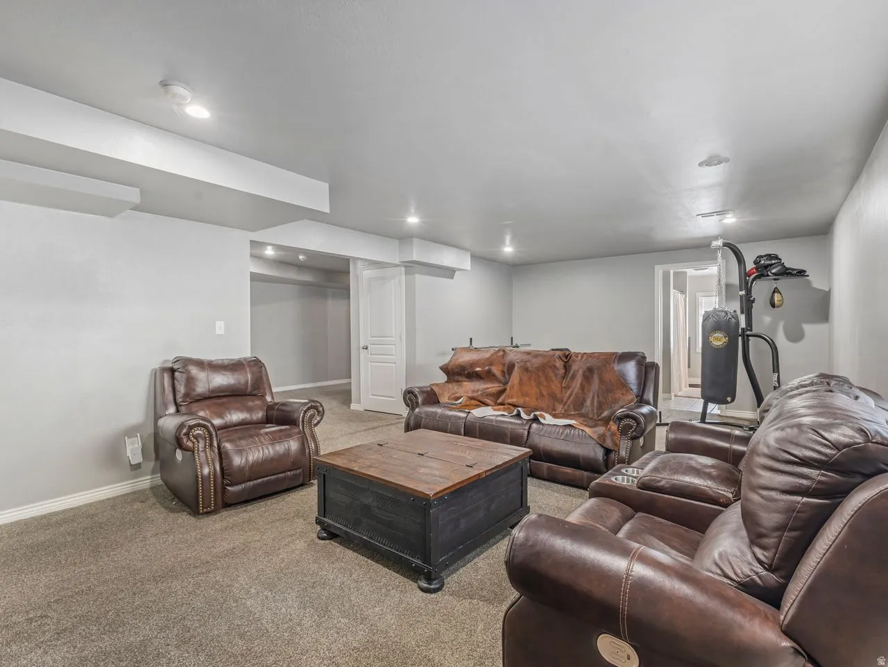 Living area with baseboards and carpet flooring