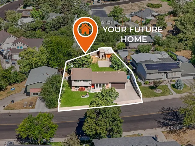 Aerial view of property's location with property parcel outlined and nearby suburban area