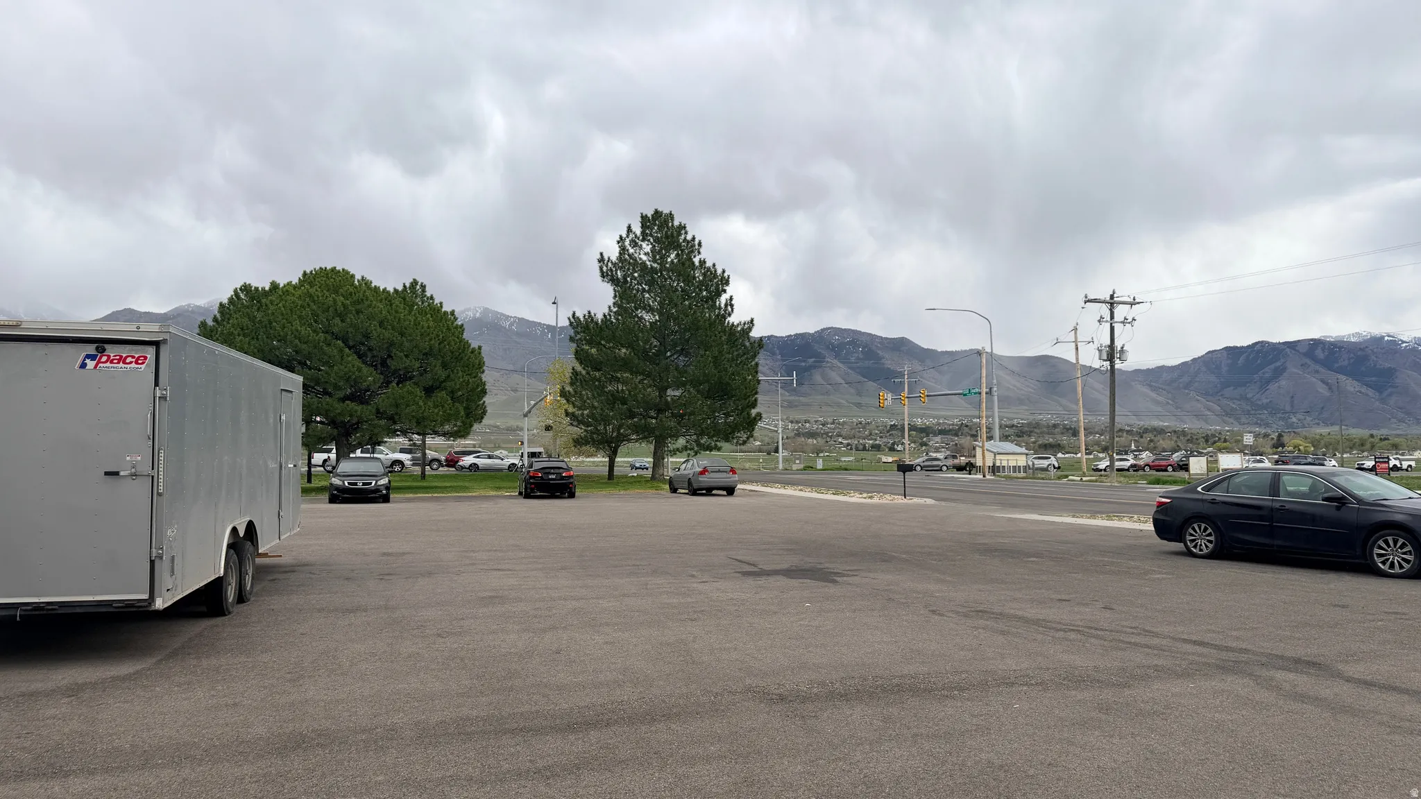View of asphalt street with a mountain view and street lighting