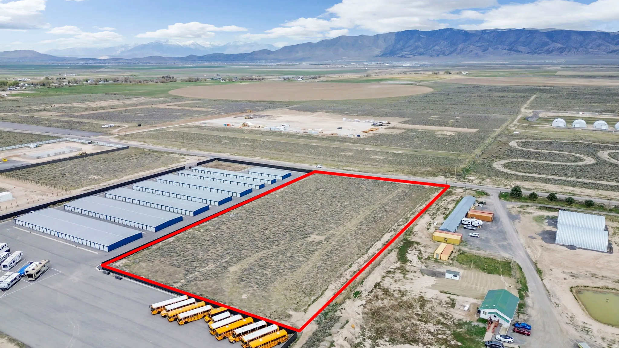 Aerial overview of property's location featuring property parcel outlined and a mountain backdrop