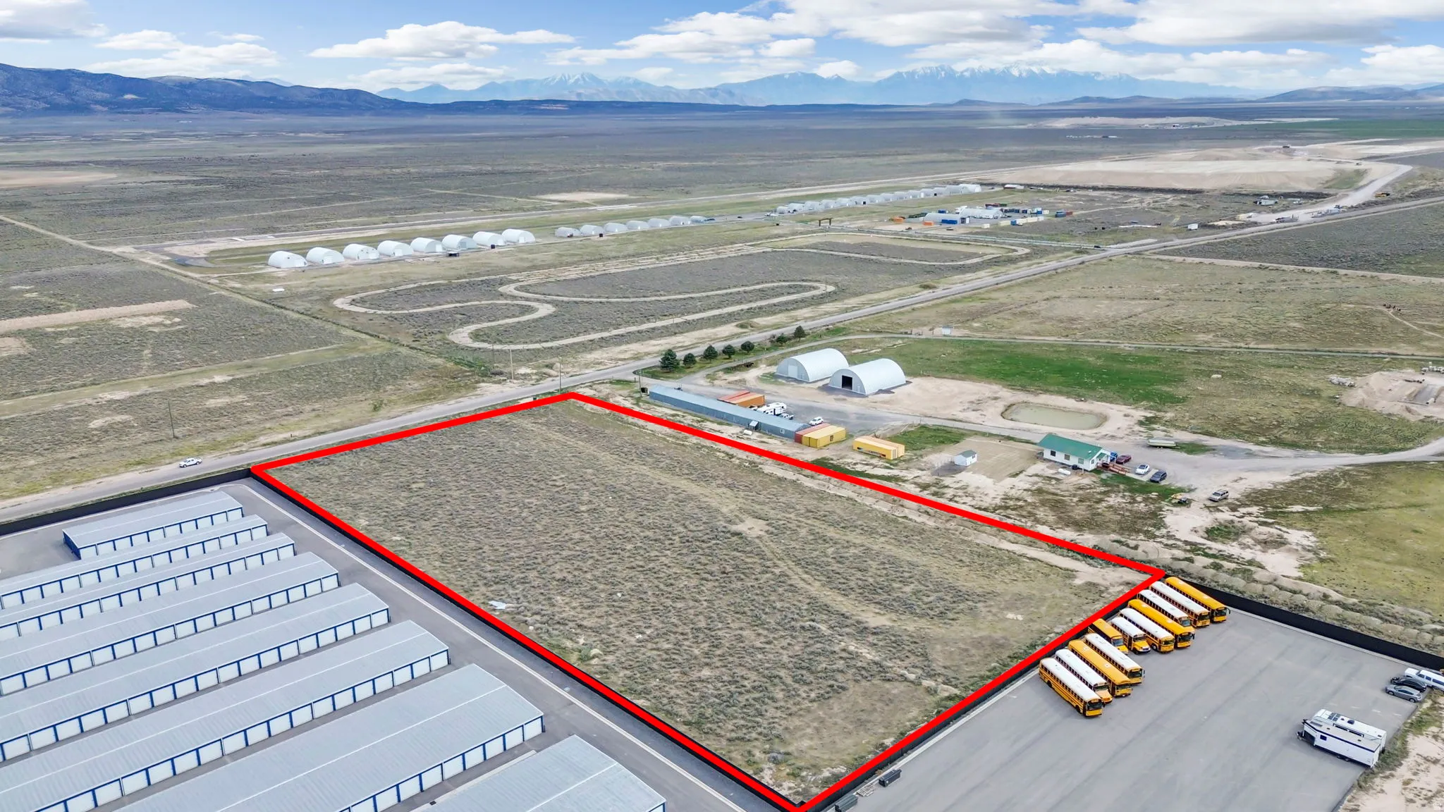 Aerial view of sparsely populated area featuring a mountain backdrop and property boundaries highlighted