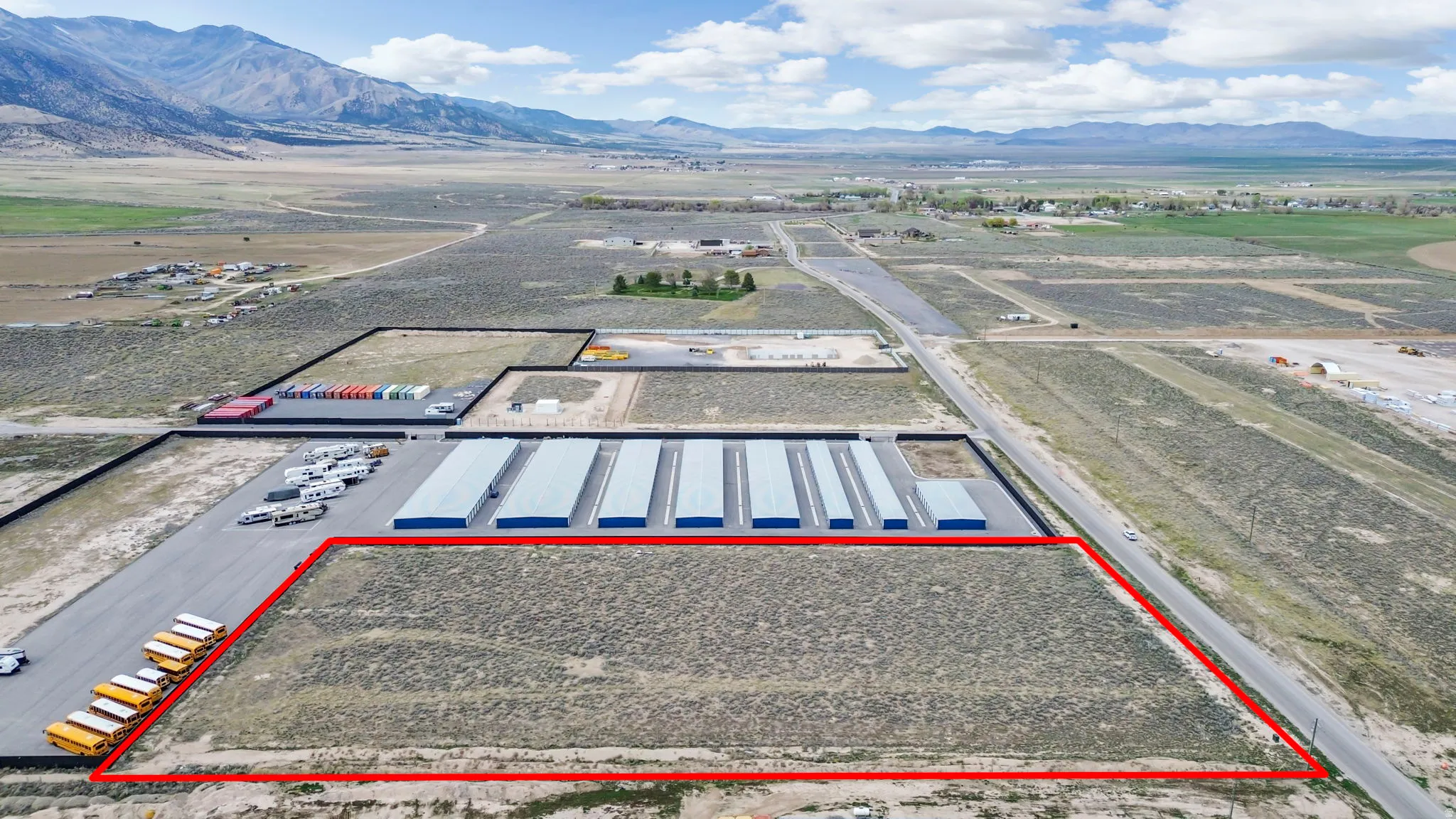 Aerial view of property's location with a mountainous background and property parcel outlined