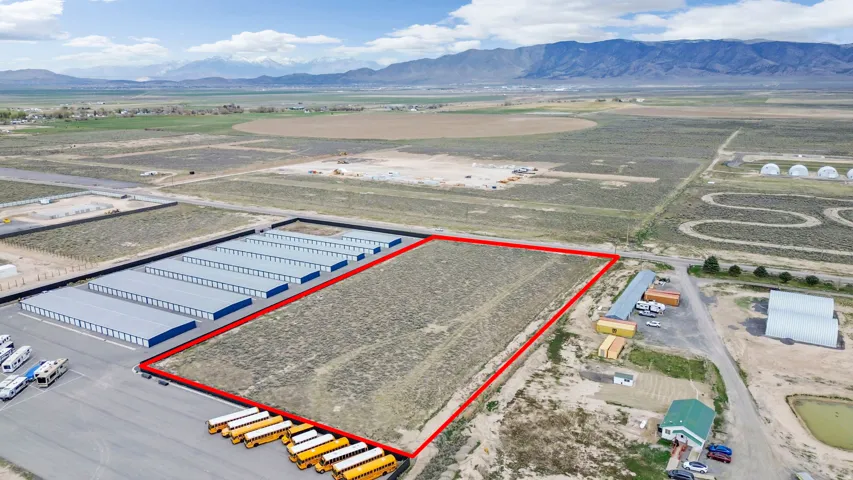 Aerial overview of property's location featuring property parcel outlined and a mountain backdrop