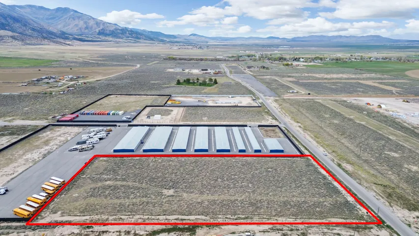 Aerial view of property's location with a mountainous background and property parcel outlined