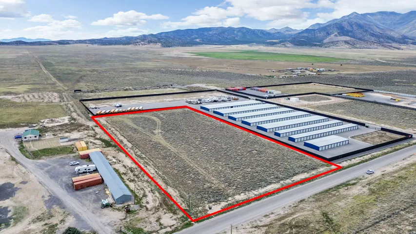 Aerial view of property's location with property parcel outlined and a mountain backdrop