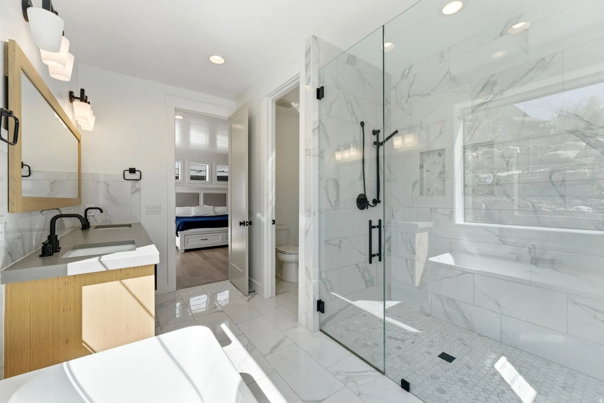 Primary Bedroom Ensuite bathroom featuring double vanity, a marble finish shower, light marble finish floors, and recessed lighting