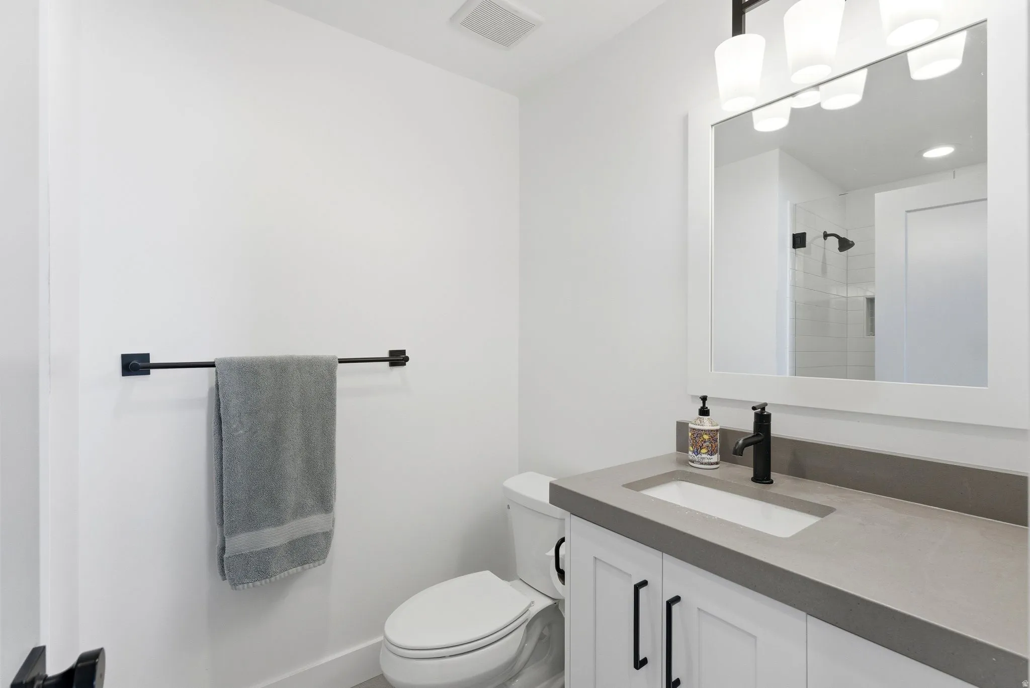 Bathroom featuring vanity and a shower