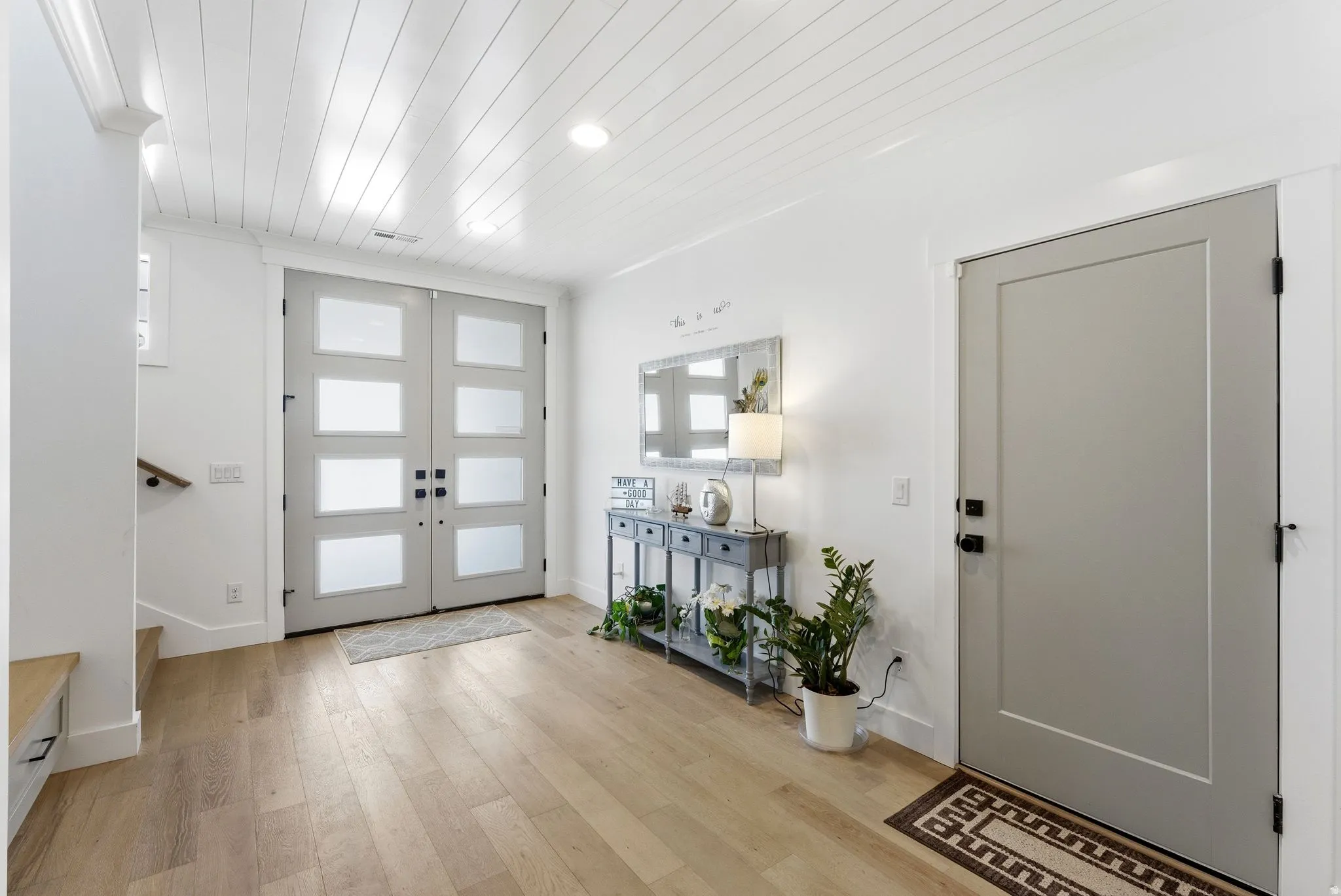 Entryway with light wood finished floors, wood ceiling, french doors, and recessed lighting