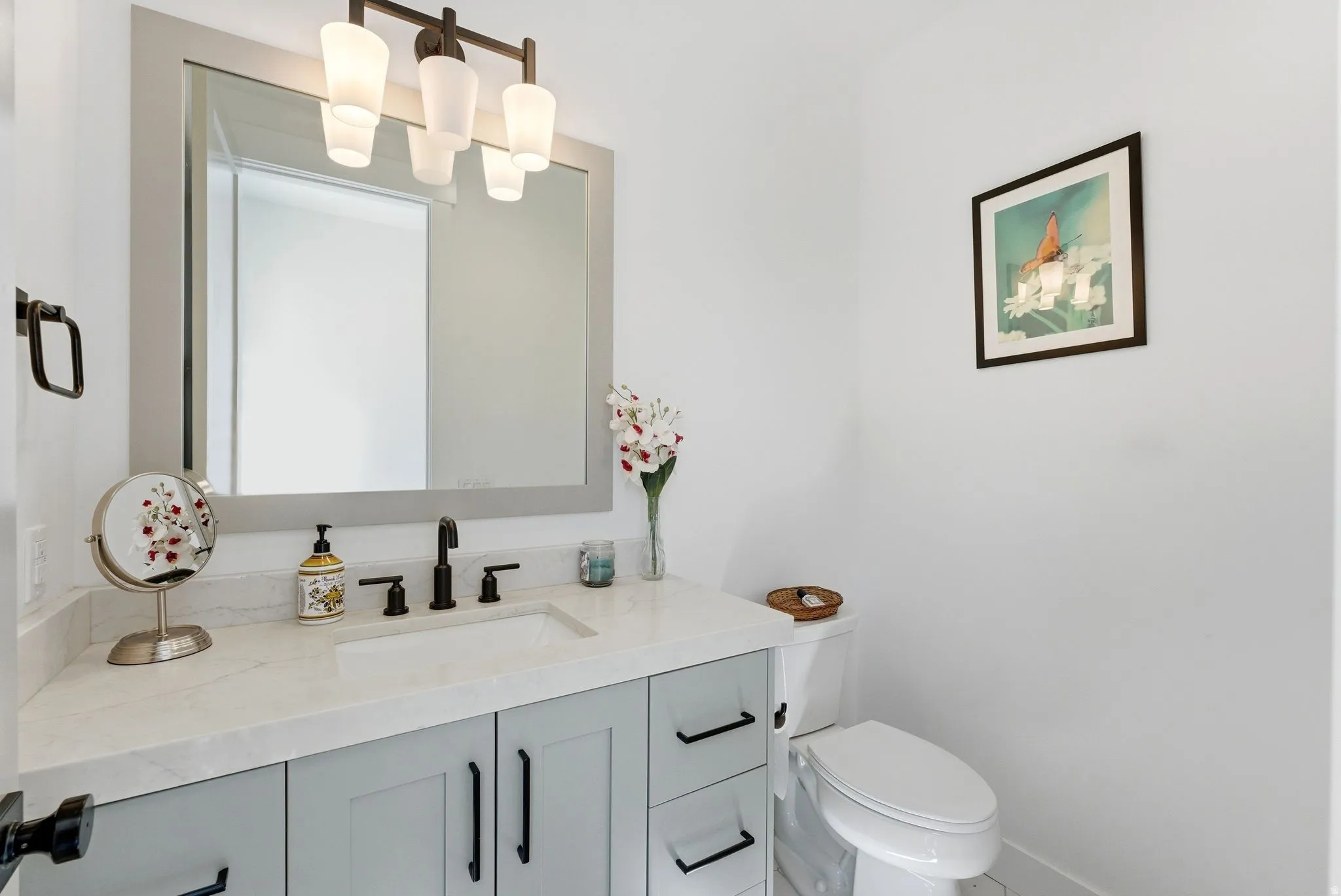 Half bathroom with vanity and toilet