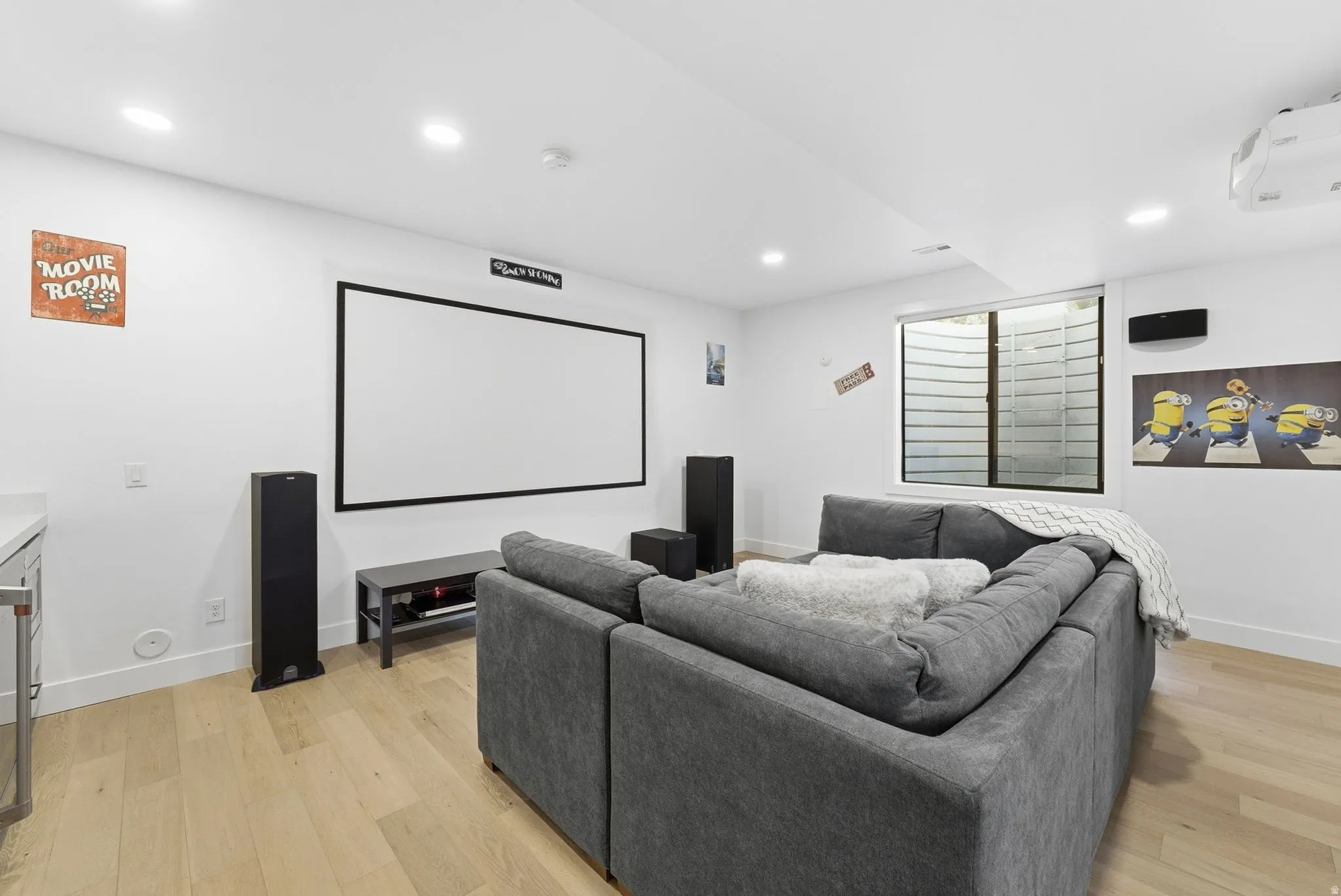 Cinema room featuring light wood-style floors and recessed lighting