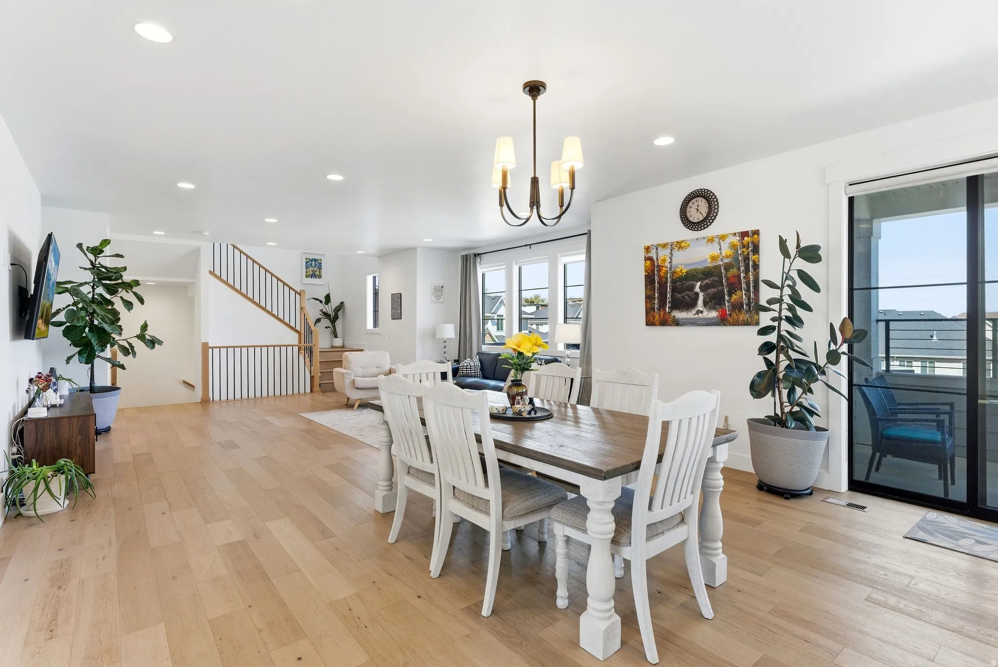 Dining area with light wood-style floors and hanging lights