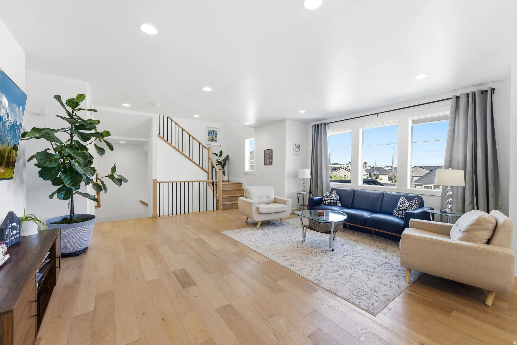 Living room featuring light wood-type flooring and recessed lighting