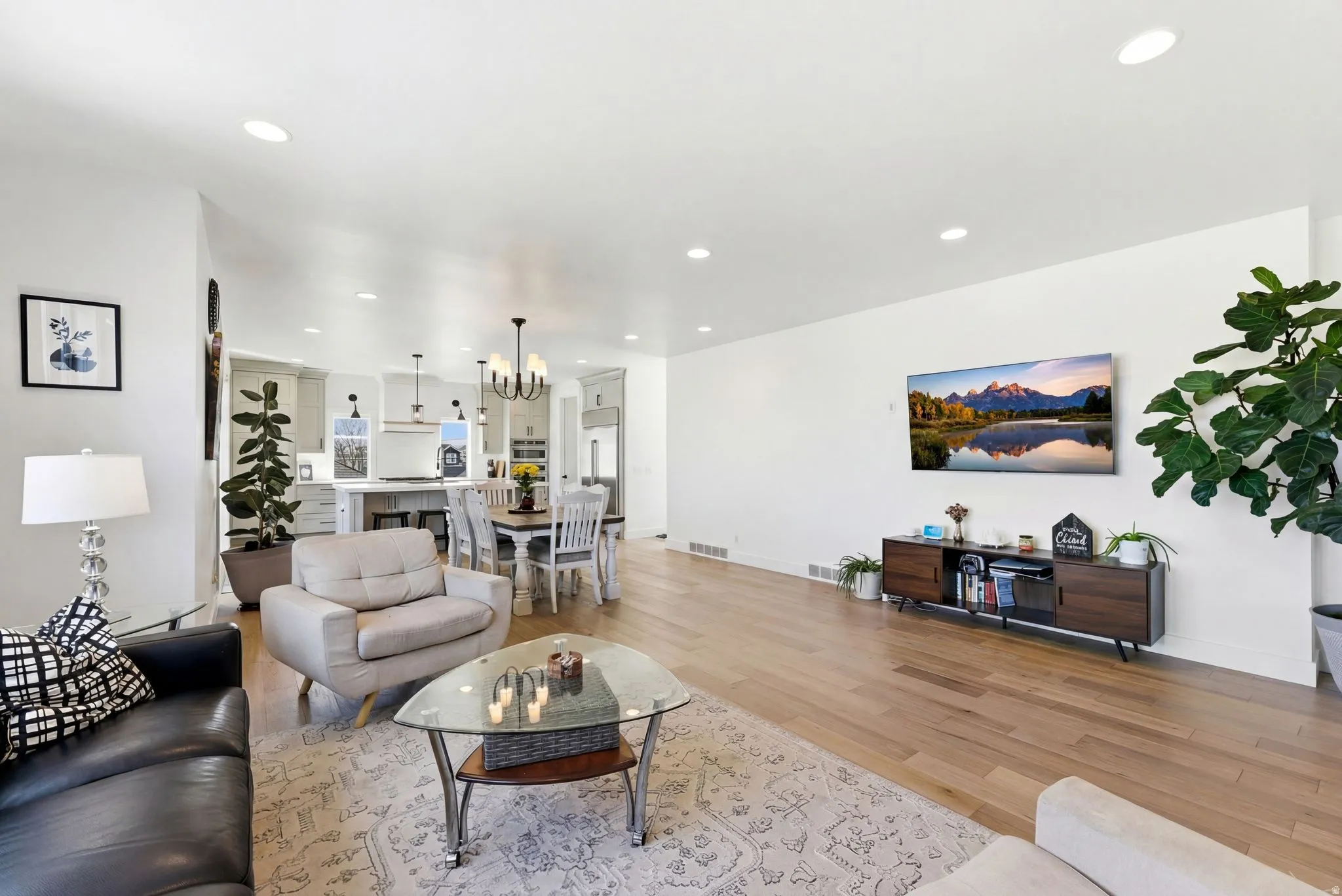 Living area featuring light wood-style flooring and a chandelier