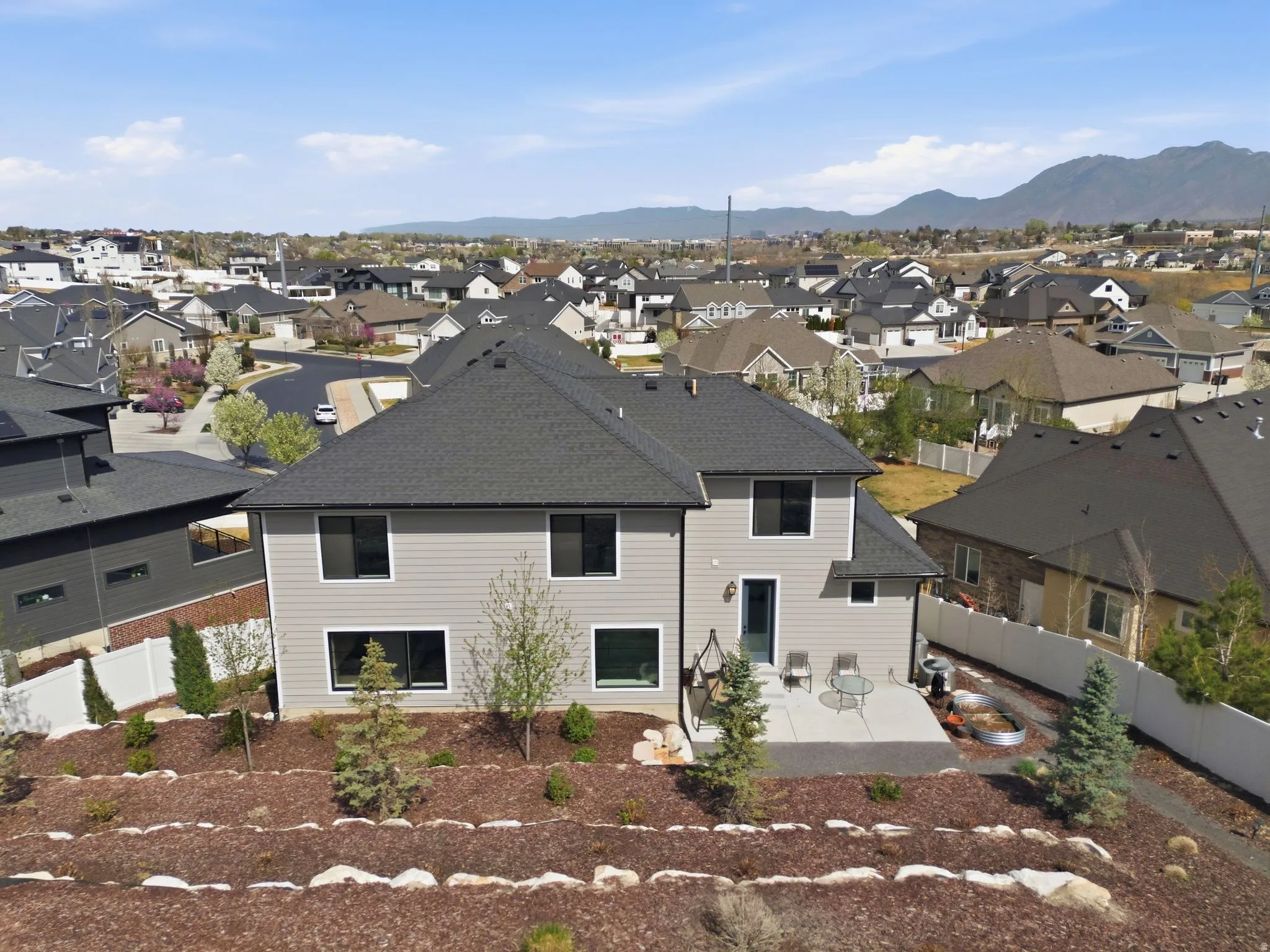 Back of house with a patio area, a fenced backyard, a residential view, and a shingled roof