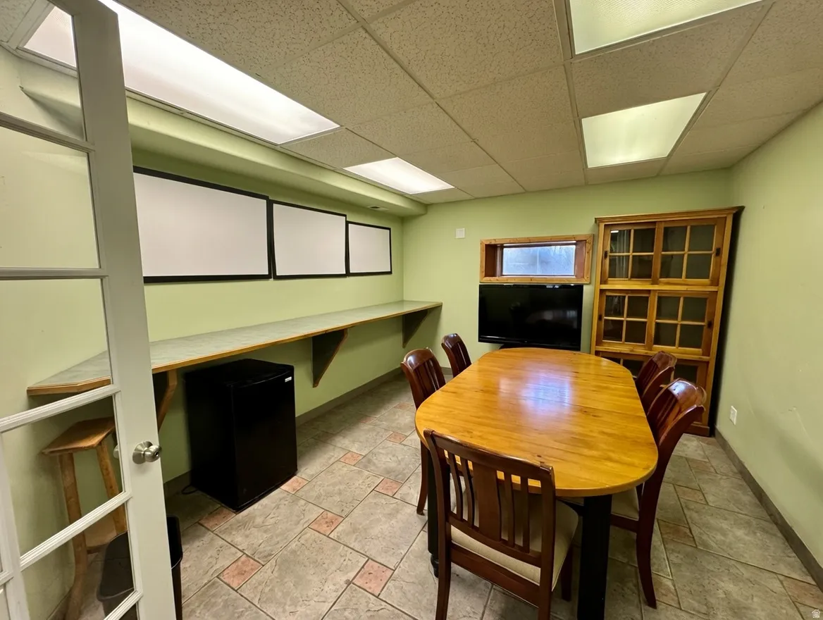 Dining area with stone tile flooring and a drop ceiling
