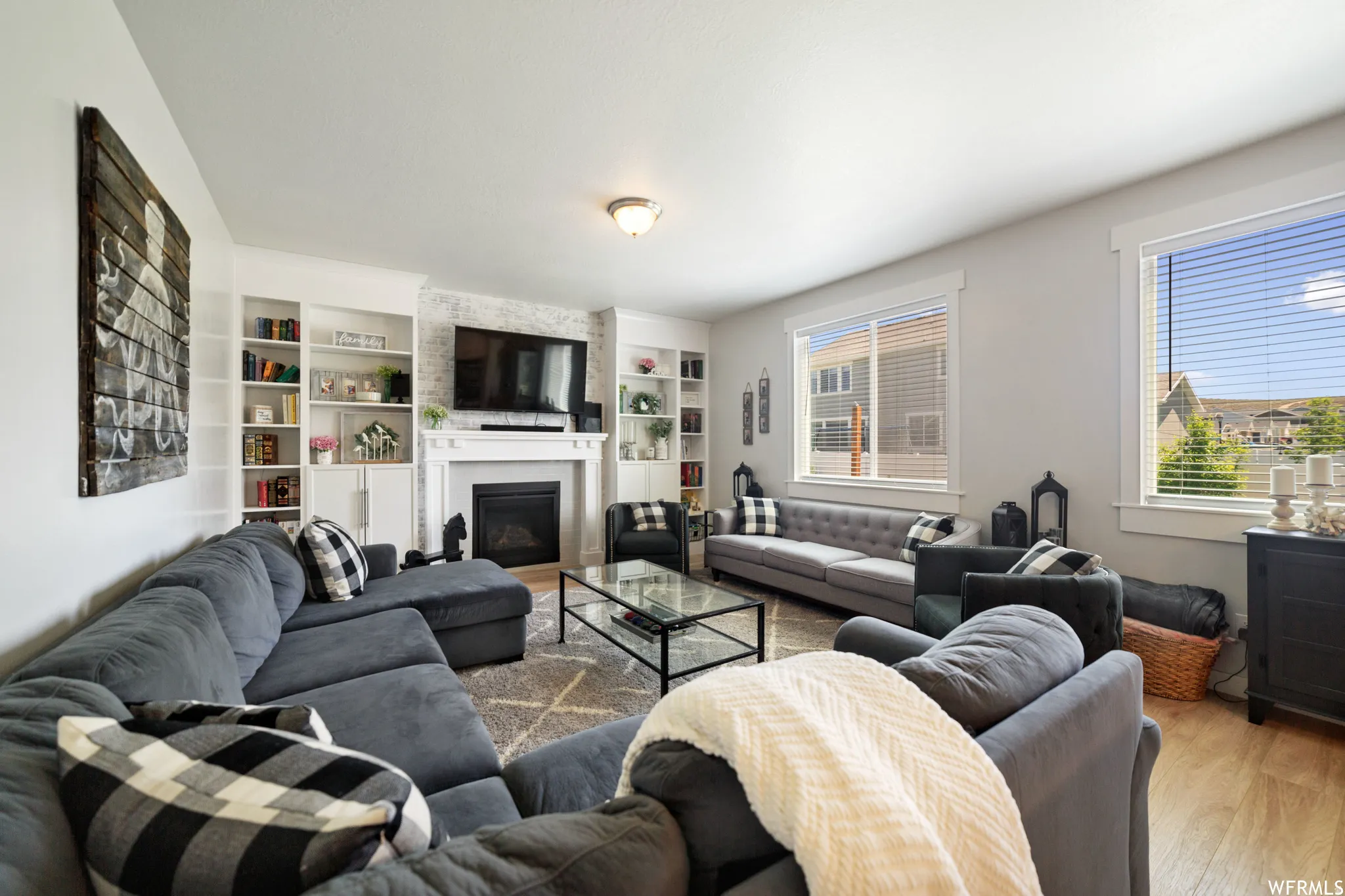 Living area with wood finished floors and a large fireplace