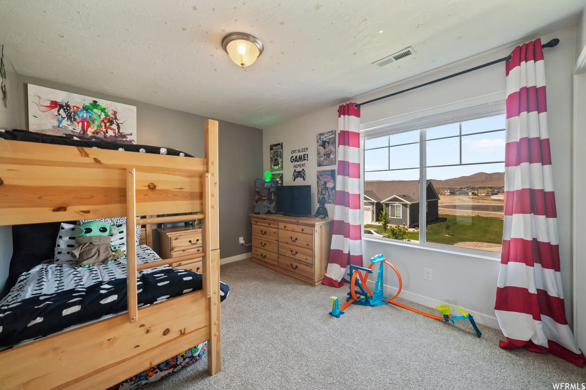 Bedroom with light carpet and baseboards