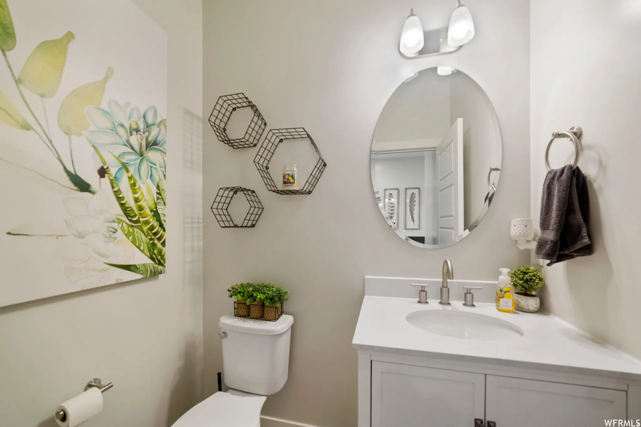 Half bathroom with toilet and vanity