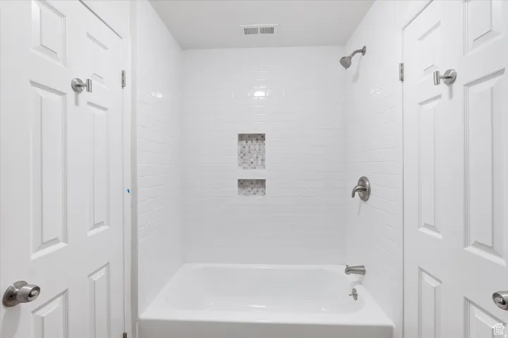 Jack and Jill bathroom with bathing tub / shower combination