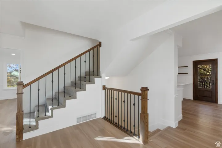 Stairs featuring wood finished floors and baseboards