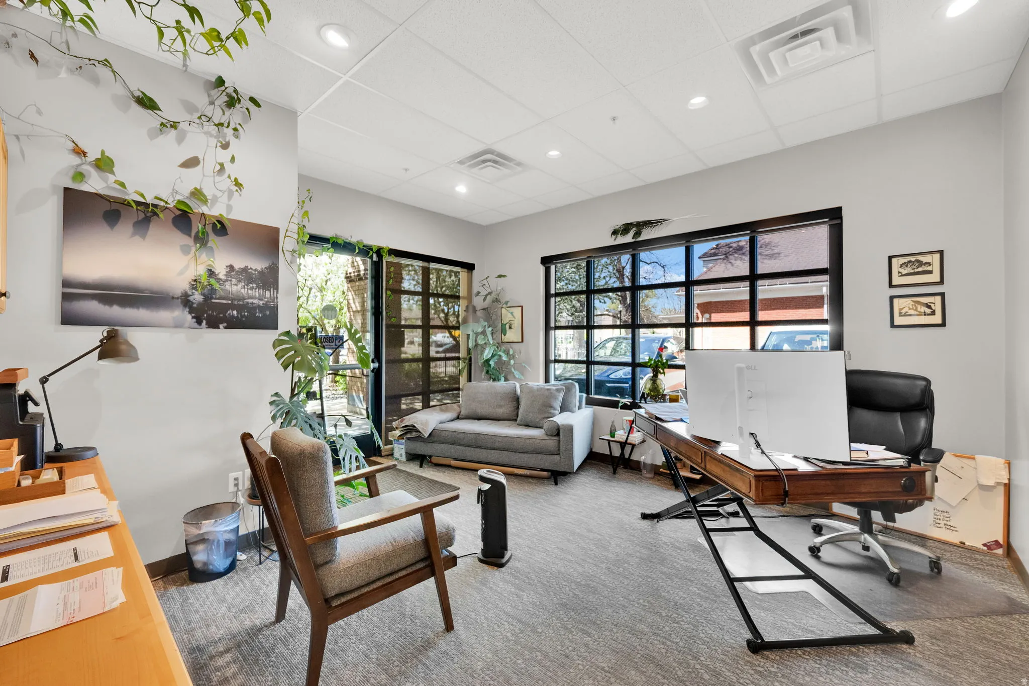 Office space featuring healthy amount of natural light, a paneled ceiling, and recessed lighting