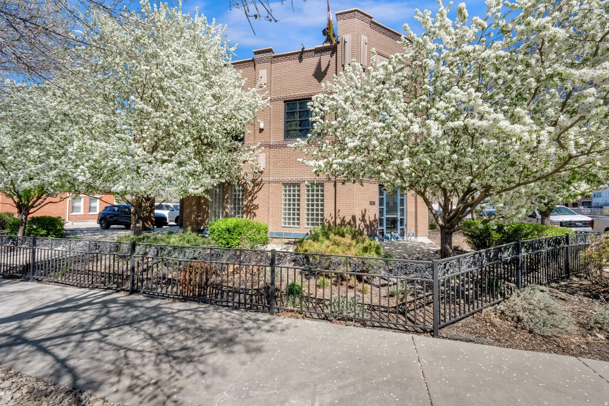 View of front facade featuring a fenced front yard and brick siding