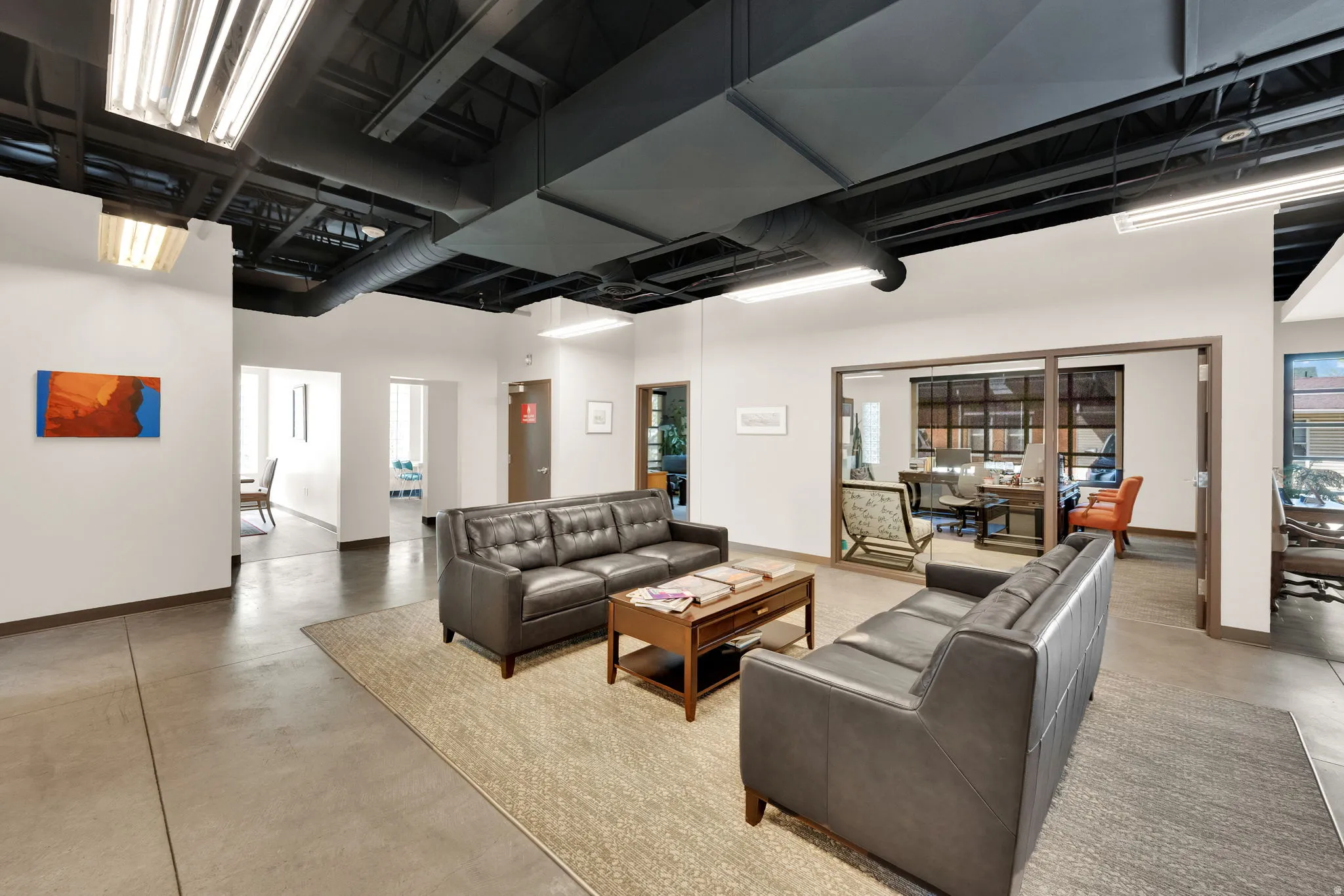 Living area with finished concrete floors and a high ceiling