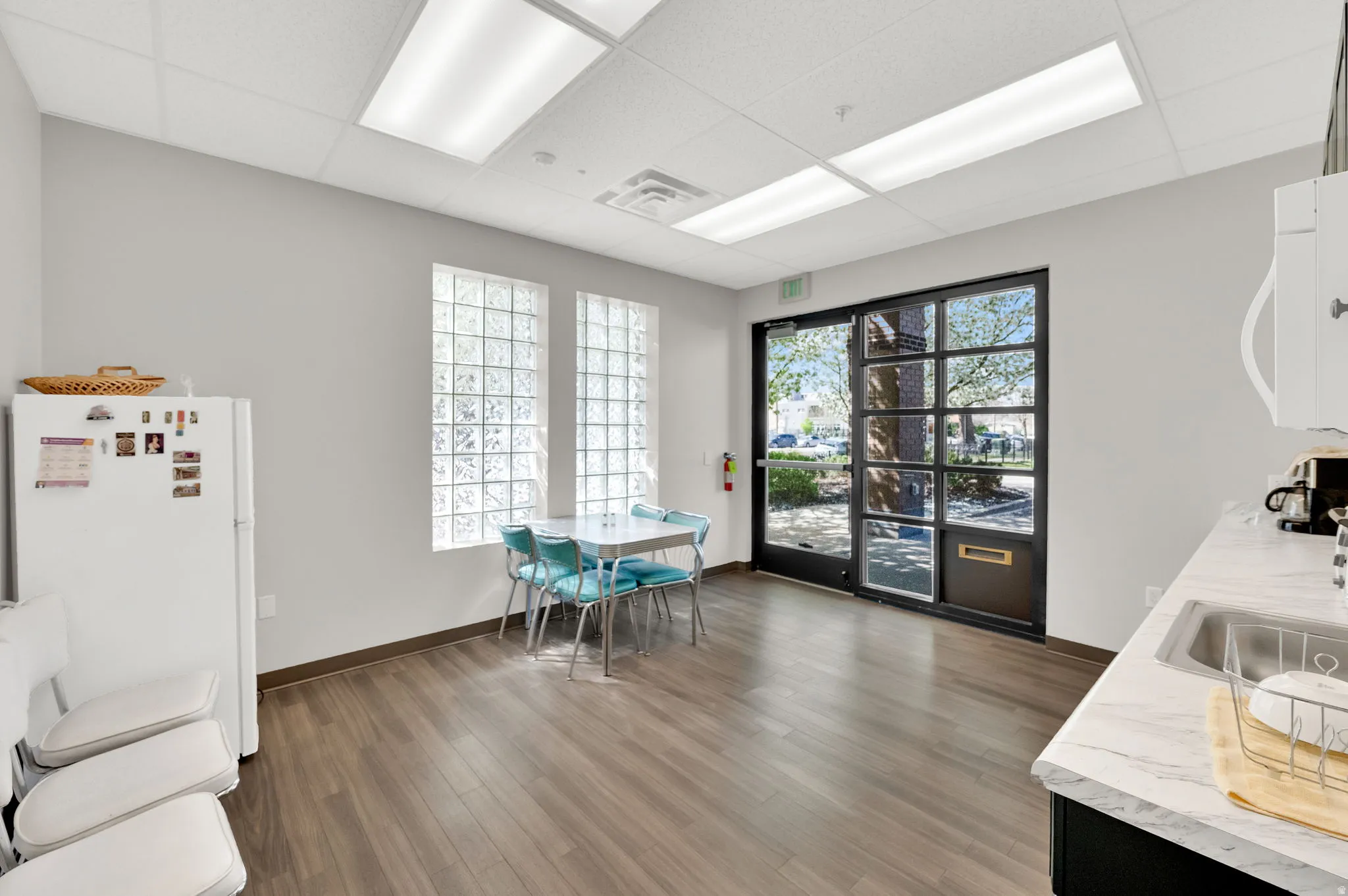 Dining room featuring a paneled ceiling and wood finished floors