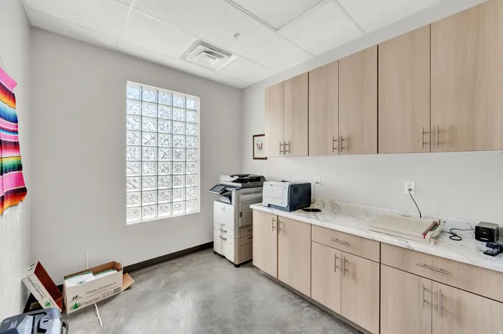Laundry area featuring a paneled ceiling and an office area