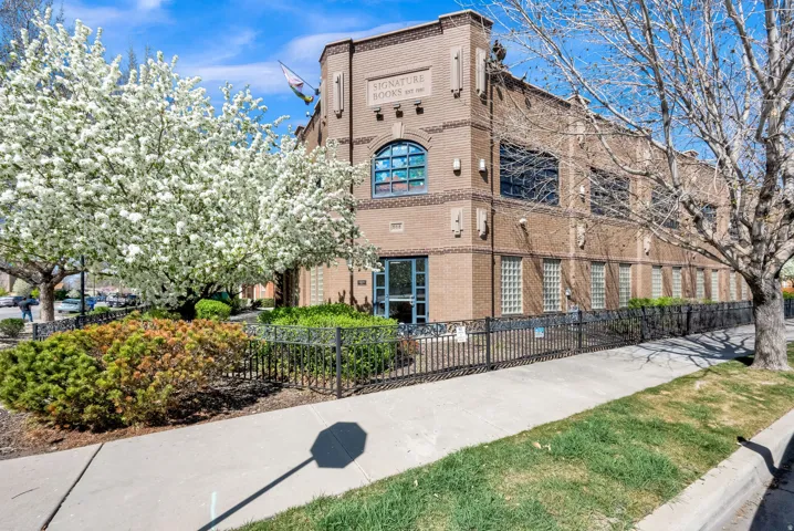 View of building exterior featuring a fenced front yard