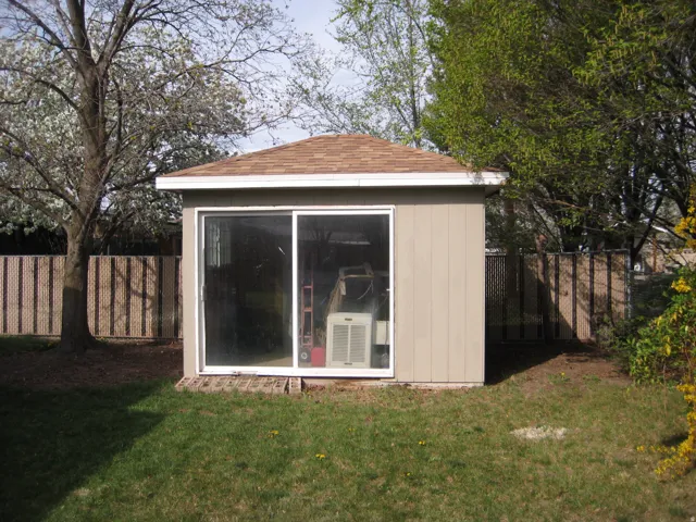 View of shed with a fenced backyard