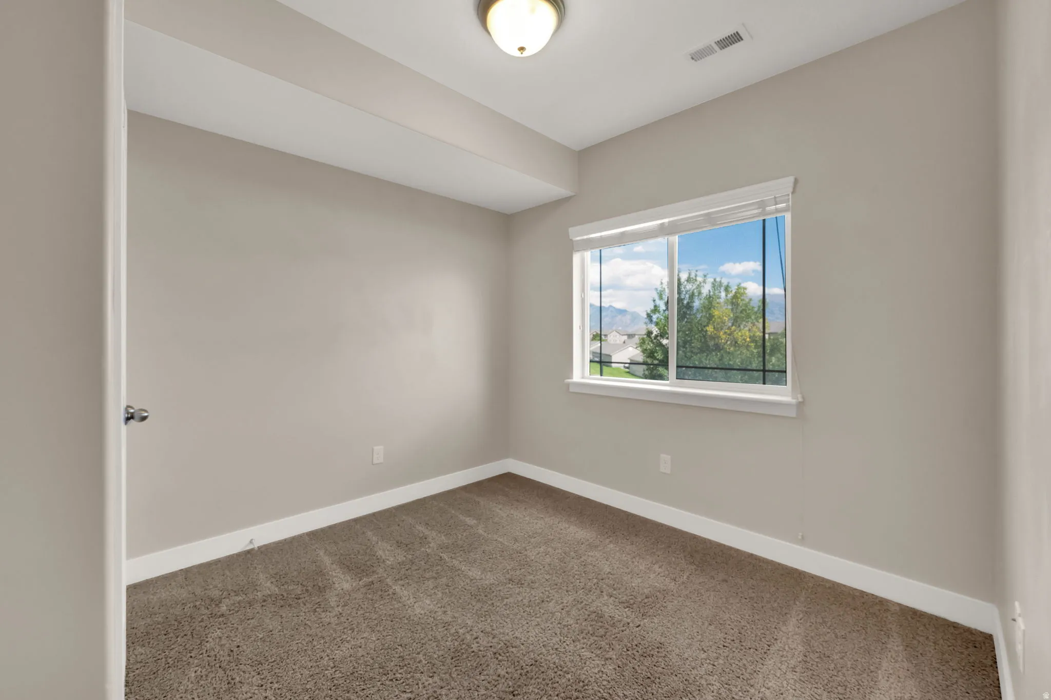 Spare room with carpet floors and baseboards