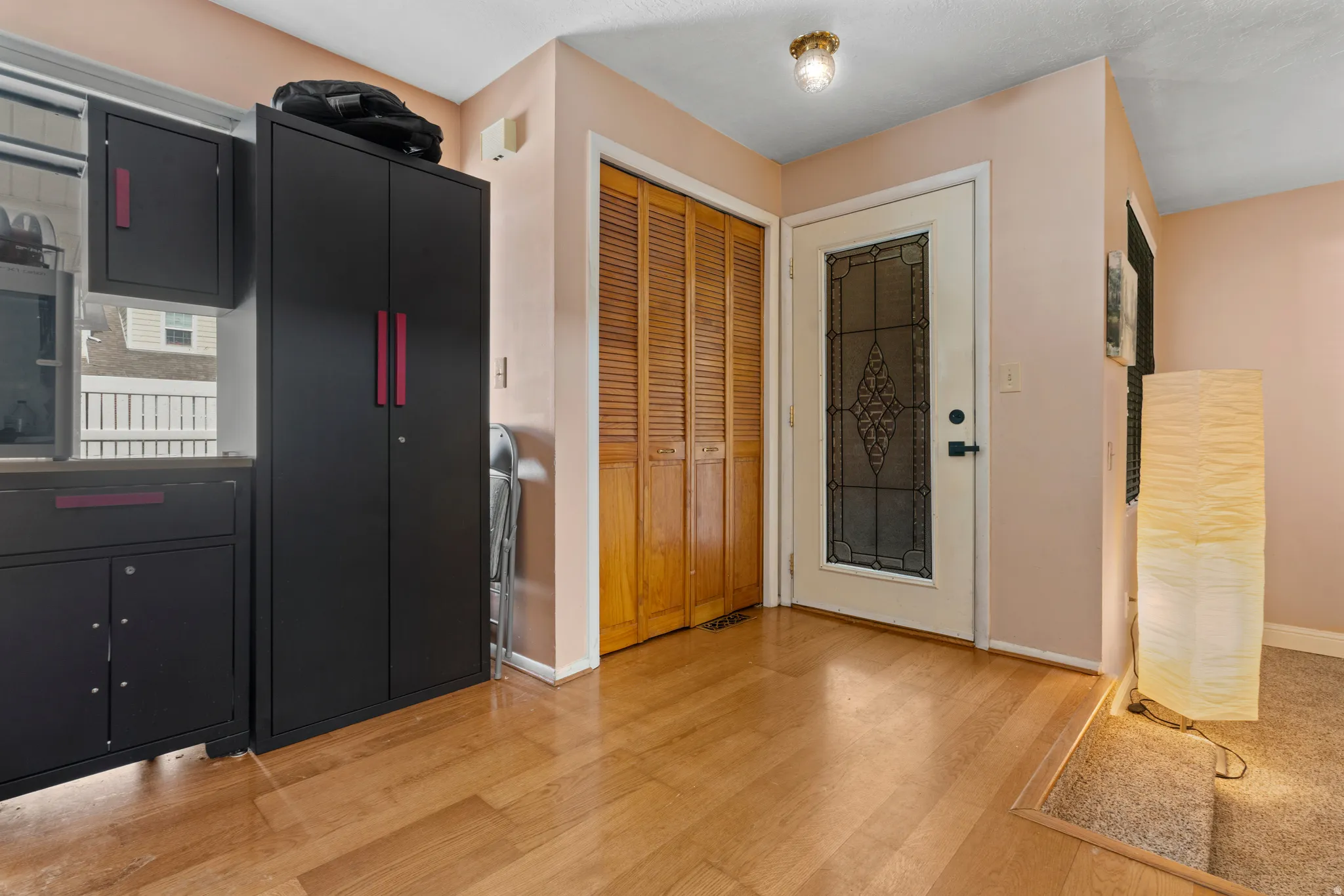 Kitchen with dark cabinets and light wood-style flooring