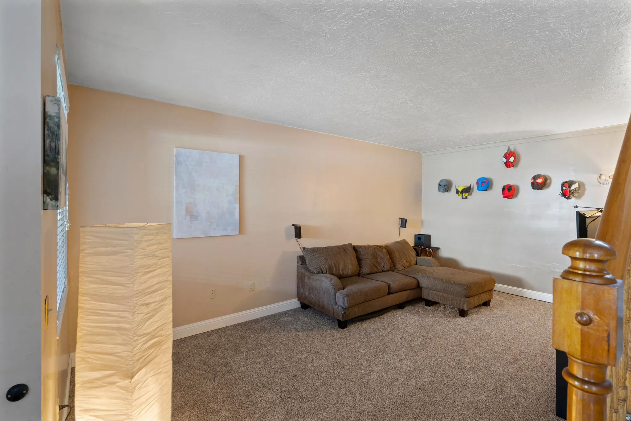 Living room with carpet flooring and a textured ceiling