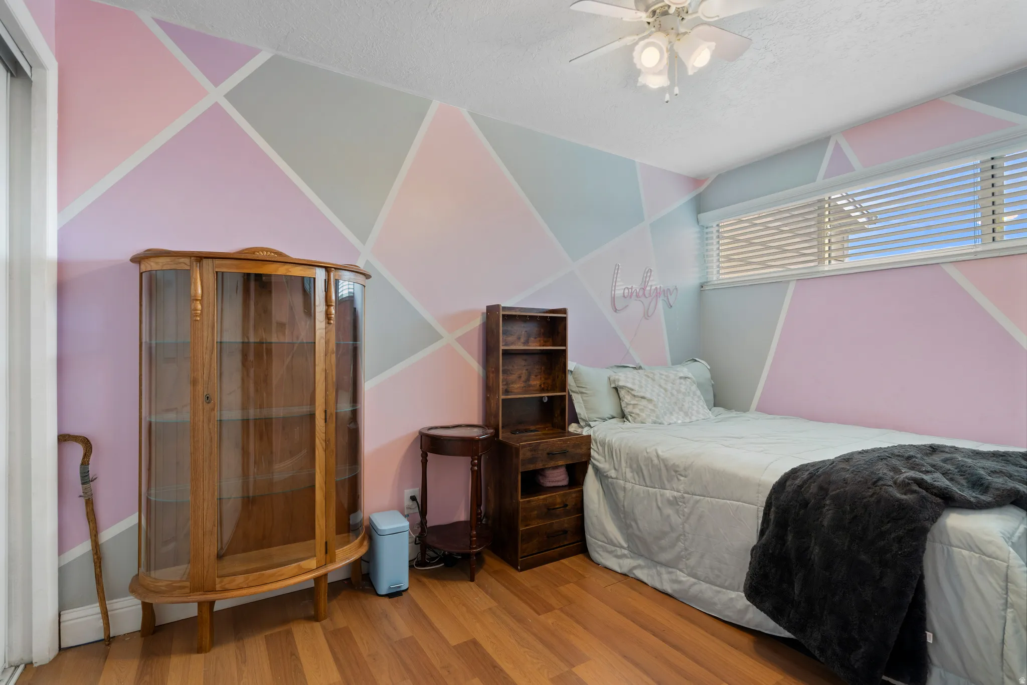 Bedroom with ceiling fan, light wood-style flooring, a sauna / steam room, and a textured ceiling