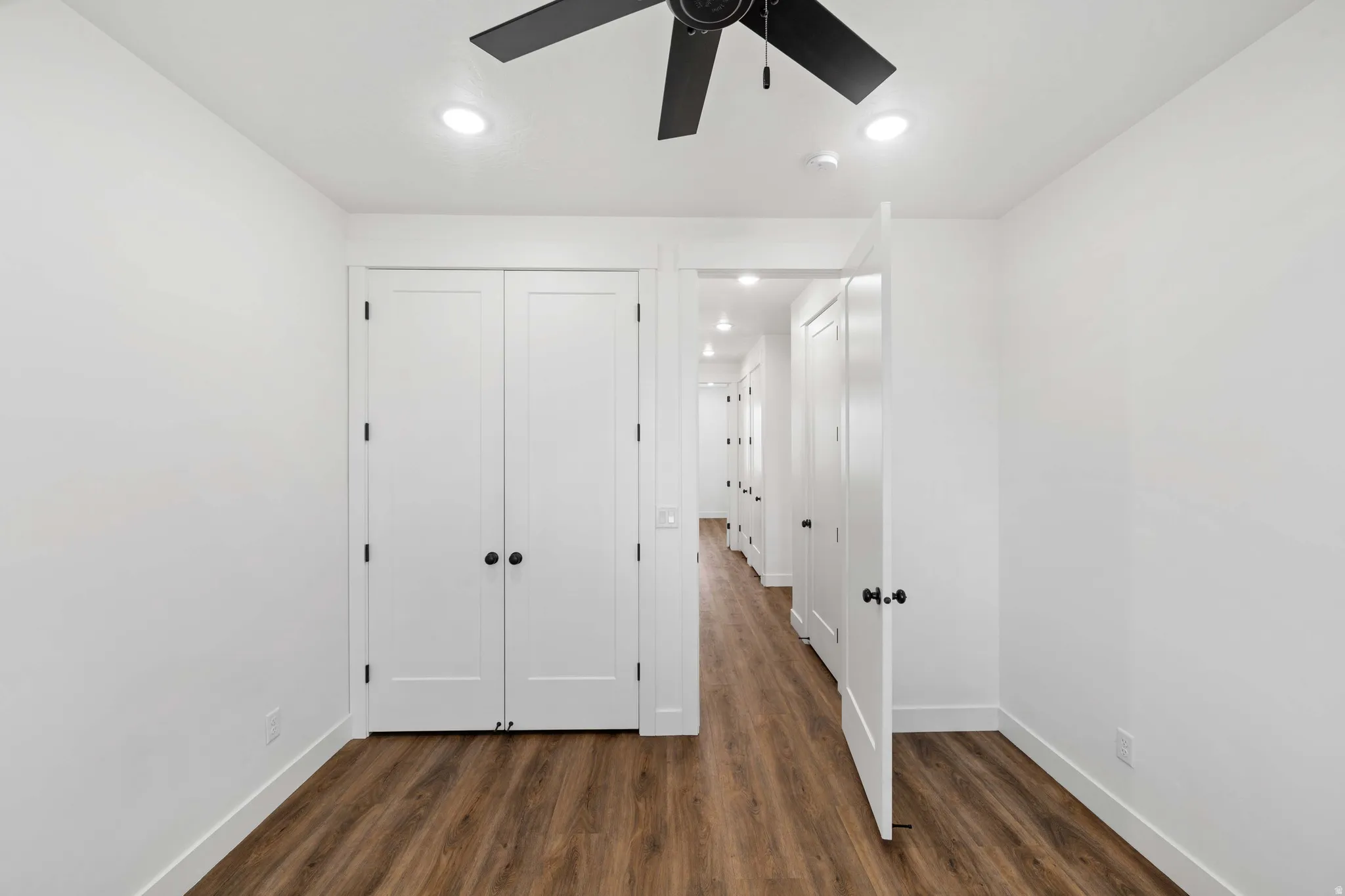 Unfurnished bedroom featuring dark wood-style floors, a closet, ceiling fan, and recessed lighting